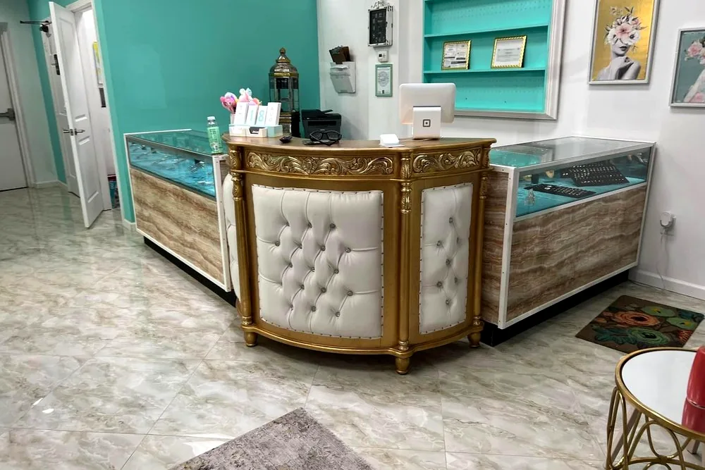 Inside The Piercing Parlour — the front desk and lit jewelry cases